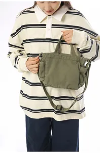 Casual green canvas shoulder bag with top handle and adjustable strap for daily commuting