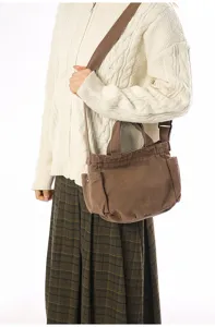 Vintage brown canvas shoulder bag, casual crossbody tote with side pockets for daily use.