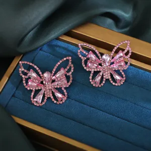 Exquisite pink rhinestone butterfly earrings, vintage crystal detailed ear studs for daily wear.