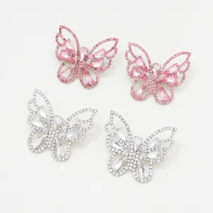 Close-up detail shot of sparkling rhinestone butterfly earrings, delicate crystal openwork design.