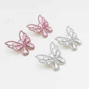 Detailed close-up view of sparkling rhinestone butterfly ear studs with crystal design