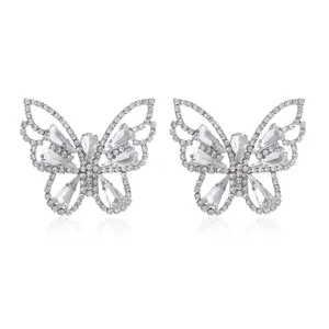 Detailed close-up of shiny rhinestone butterfly earrings, hollow claw chain design, sparkling.