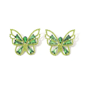 Detailed close-up of sparkling green crystal rhinestone butterfly hollow earrings.