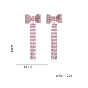 Detailed view of long pink rhinestone bow tassel earrings, elegant and sparkling 10cm length
