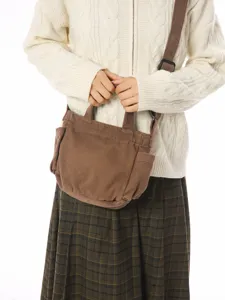 Retro canvas shoulder bag for women, large capacity casual crossbody tote for daily commuting.