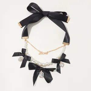 Vintage multi-layer pearl necklace with black bows and crystal charms for women.