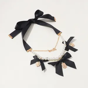Detailed view of the vintage black bow pearl layered choker necklace with cute heart charms.