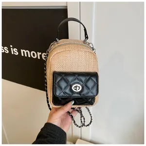 Mini straw backpack detail with black quilted front pocket, top handle and chain straps.
