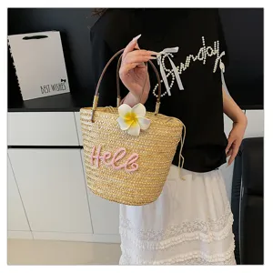 Sweet woven straw handbag for women, cute floral decor, perfect beach holiday tote bag.