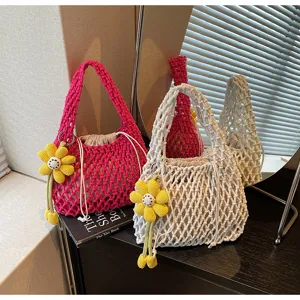 Candy color woven mesh handbag detail showing hollow knit design and cute sunflower charm.