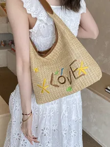 Borsa a tracolla in paglia alla moda con design ricamato, ideale per le vacanze estive al mare.