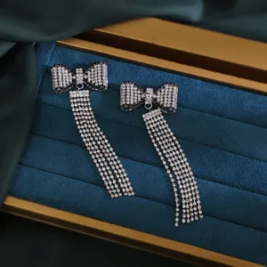 Detailed view of luxury Y2K rhinestone bow long tassel earrings sparkling crystal drop design.