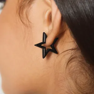 Korean minimalist hollow star earrings for women, stylish zinc alloy geometric black studs.