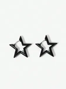 Close-up of black hollow pentagram hoop earrings detail view minimalist metal jewelry.