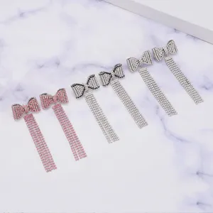Detailed shot of sparkling rhinestone bow tassel earrings, elegant Y2K fashion jewelry for women.