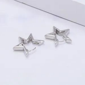 Detailed close-up of minimalist silver star huggie hoop earrings, chic geometric style.