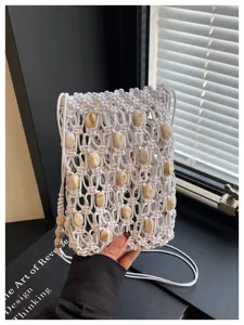 Boho macrame beaded phone bag, white woven crossbody bag with detailed handmade knots and beads.