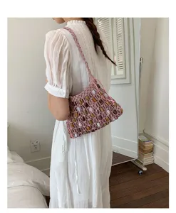 Bohemian woven shoulder bag detail, pink string design with colorful beads for beach wear.