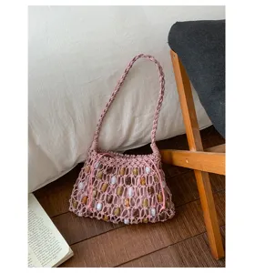 Boho pink braided rope shoulder bag with colorful beads, stylish beach hobo bag for women.