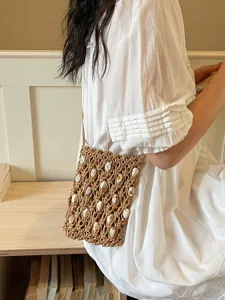Bohemian hollow out beaded straw woven crossbody phone bag for women beach vacation.