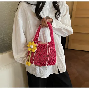 Woven cotton string handbag in bright pink with inner pouch and cute yellow flower charm.
