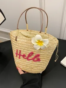 Sweet straw woven handbag for women, summer beach bucket bag with cute flower and letter design.