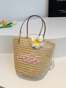 Sweet straw woven handbag for women, cute beach tote bag with floral decor and pink letters.