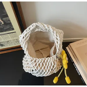 White cotton woven mesh handbag, hollow crochet tote bag with cute yellow flower charm detail.
