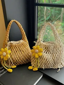 Chic woven mesh tote bag with flower pendant, hollow cotton beach handbag for women.
