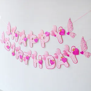 Pink happy birthday banner with butterfly wings and glitter hearts for baby party decoration.