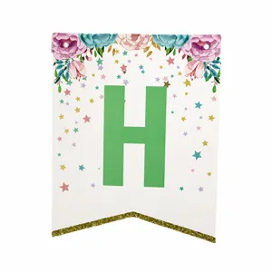 Close-up detail of paper birthday party banner letter H with floral and stars decoration.