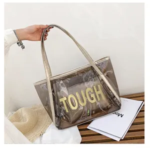 Close-up of clear jelly tote bag, large transparent shoulder bag detail with inner pouch for beach.