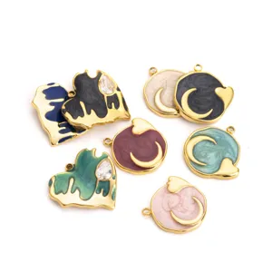 Close-up details of multi-color enamel heart and circle moon jewelry pendant charms accessories.