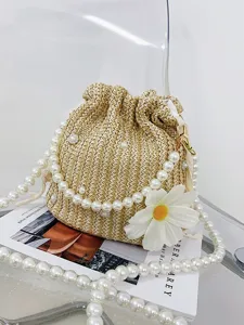 Woven straw bucket bag with pearl chain strap and daisy flower, perfect beach crossbody handbag.