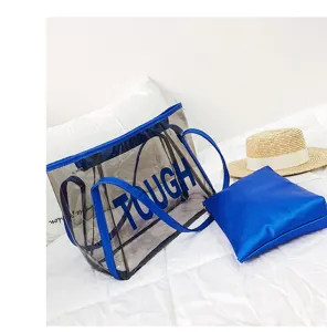 Clear PVC tote bag with blue trim and large letters for summer beach vacation use.