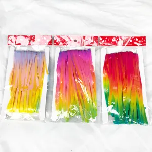 Detailed view of colorful gradient fringe curtains for festive wedding and party backdrop.