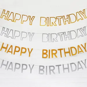 Close-up detail of gold and silver mirror finish happy birthday letter banner party decor.