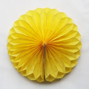 Yellow paper honeycomb ball decoration, folded honeycomb paper ornament for home or party decor.