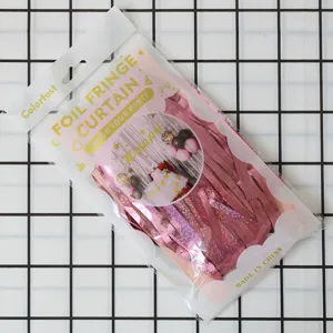 Pink foil fringe curtain for party decoration, shiny metallic tinsel door backdrop.
