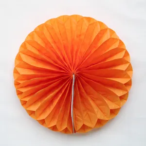 Close-up detail of orange paper honeycomb ball, perfect for party and event decoration.