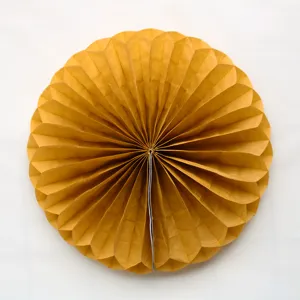 Yellow paper honeycomb ball decoration for table display, folding paper fan craft party decor.