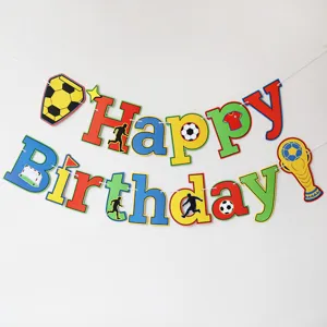 Detailed view of colorful soccer themed birthday party banner decoration with football elements.