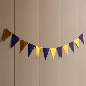 Close up view of blue and gold metallic triangular pennant garland for party decoration details.