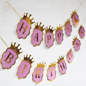 Pink glitter crown happy birthday banner party decoration detail view hanging on white wall