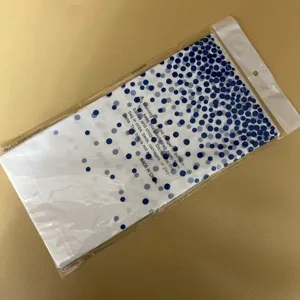 Wegwerp tafelkleed verpakking detail blauwe stippen plastic zak helder zicht product.