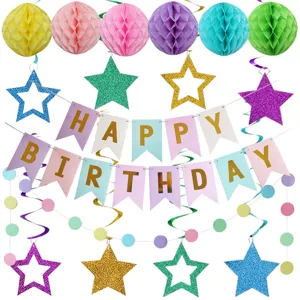 Colorful birthday party decoration set with paper honeycomb balls, stars banner, and hanging swirls.