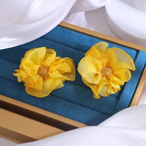 Handmade yellow chiffon fabric flower earrings detail view, elegant floral design.
