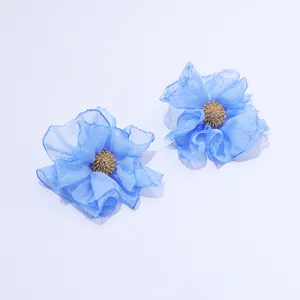 Handmade blue chiffon fabric flower earrings detail, elegant retro style jewelry for women.