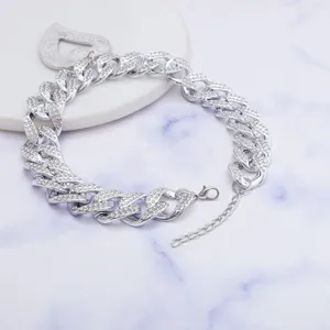 Detailed view of the punk style rhinestone cuban chain necklace with a heart pendant.