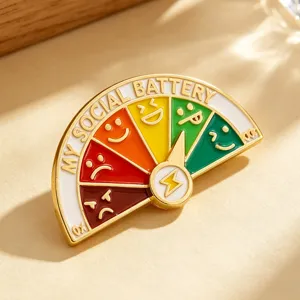 Close-up of sliding social battery enamel pin showing mood levels and emoji details